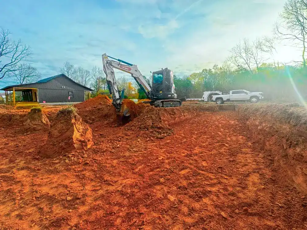 An excavator clearing a lot
