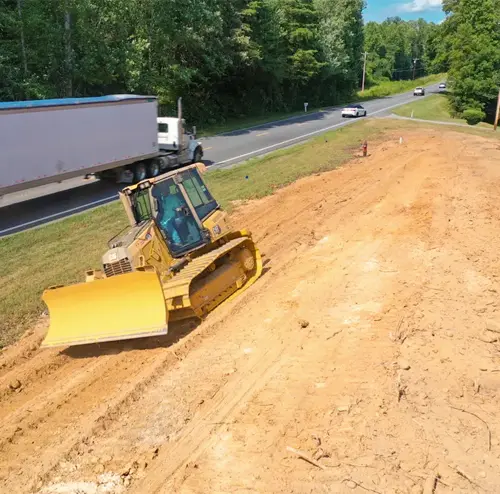 A bulldozer clearing a lot