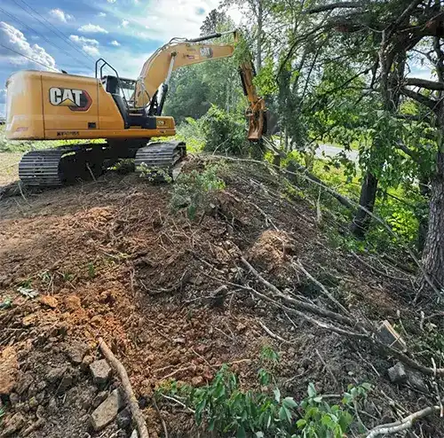 An excavator clearing trees